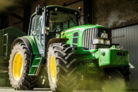 green and yellow tractor in garage